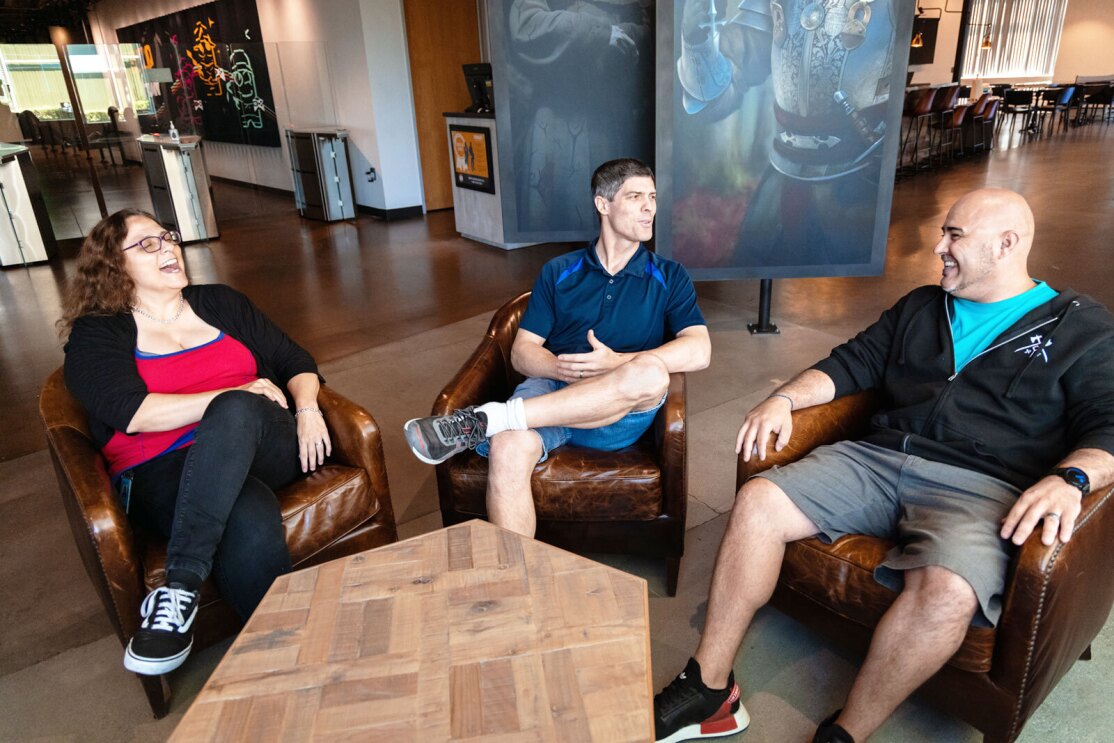 An image of Petra Beringer, Marcus Barber, and Jorge Oseguera sitting down having a conversation at the Amazon Games Orange County studio.