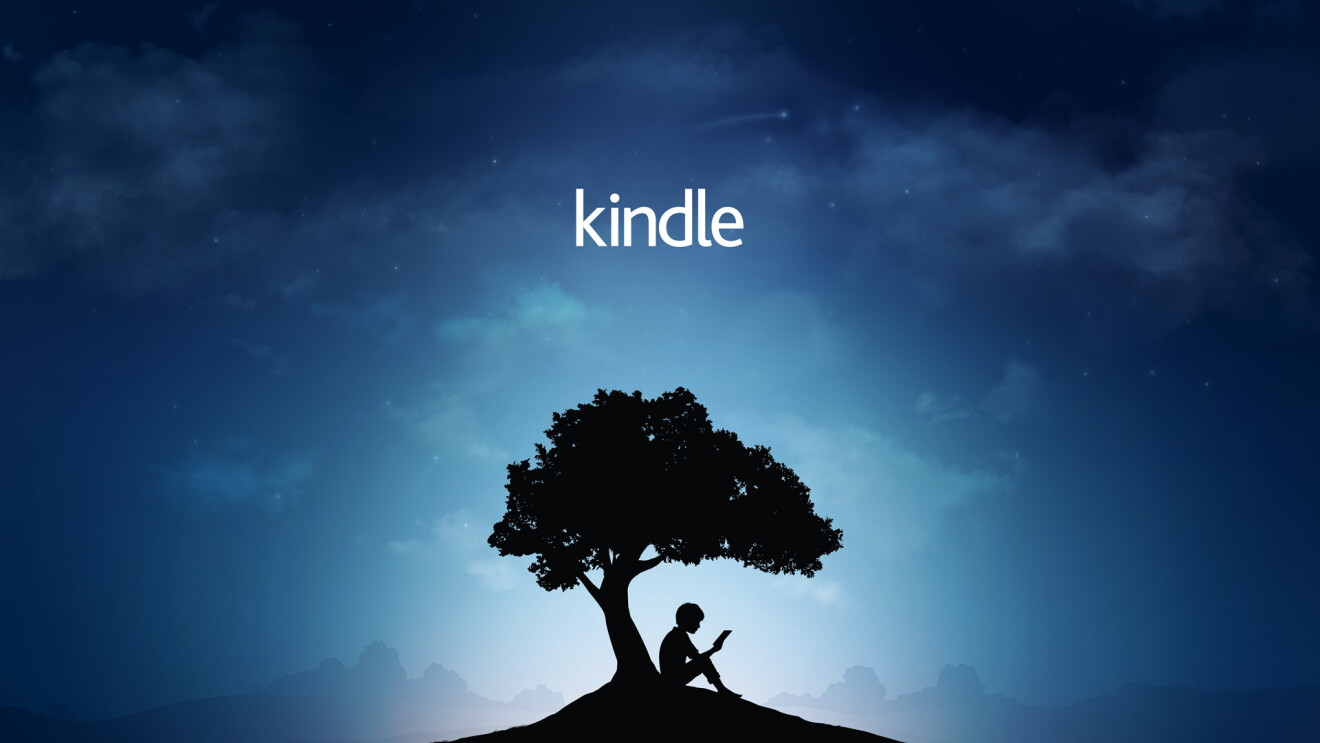 Amazon's Kindle Reader Tree brand image: a boy sits under a tree reading a book. 