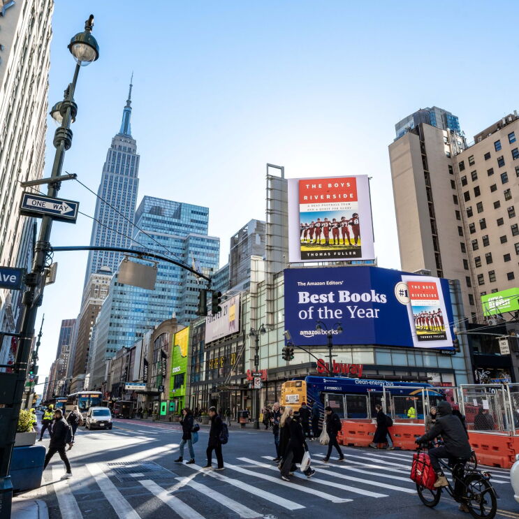 Busy Manhattan intersection featuring Amazon's Best Books billboard