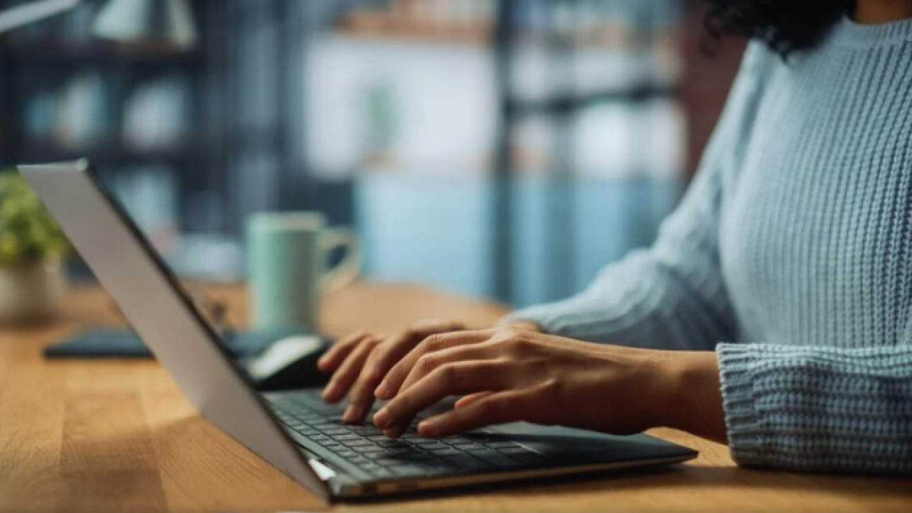 A person typing on a laptop
