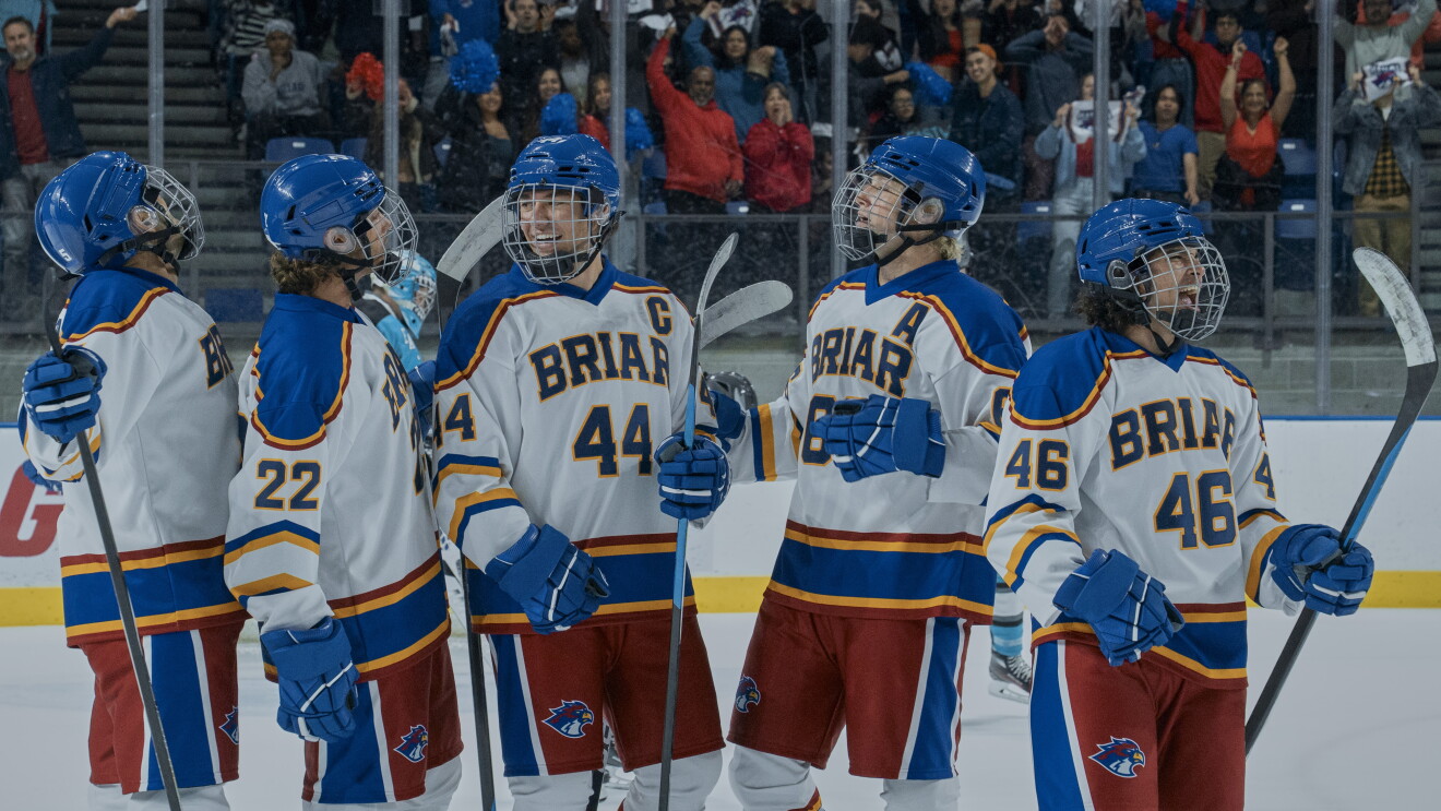 'Off Campus' Ice hockey team 'Briar' lined up on the rink, players wearing blue helmets and white jerseys