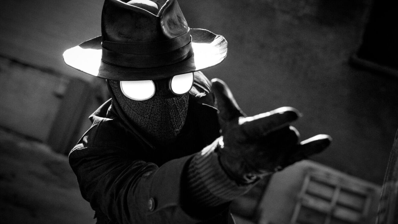 Mysterious masked person in detective-like attire gesturing dramatically.