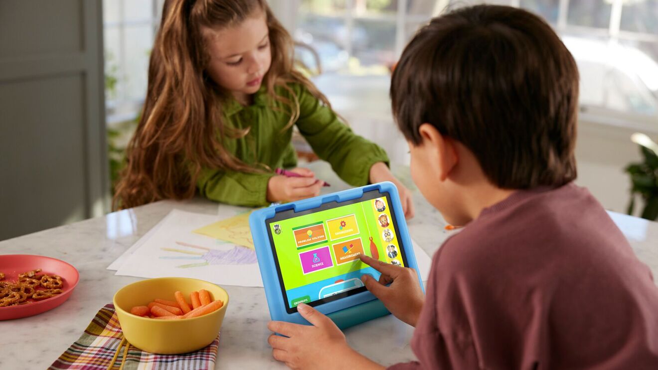 Children at table with snacks and Amazon Fire tablet