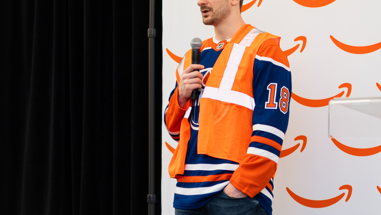 hockey player helping package boxes 