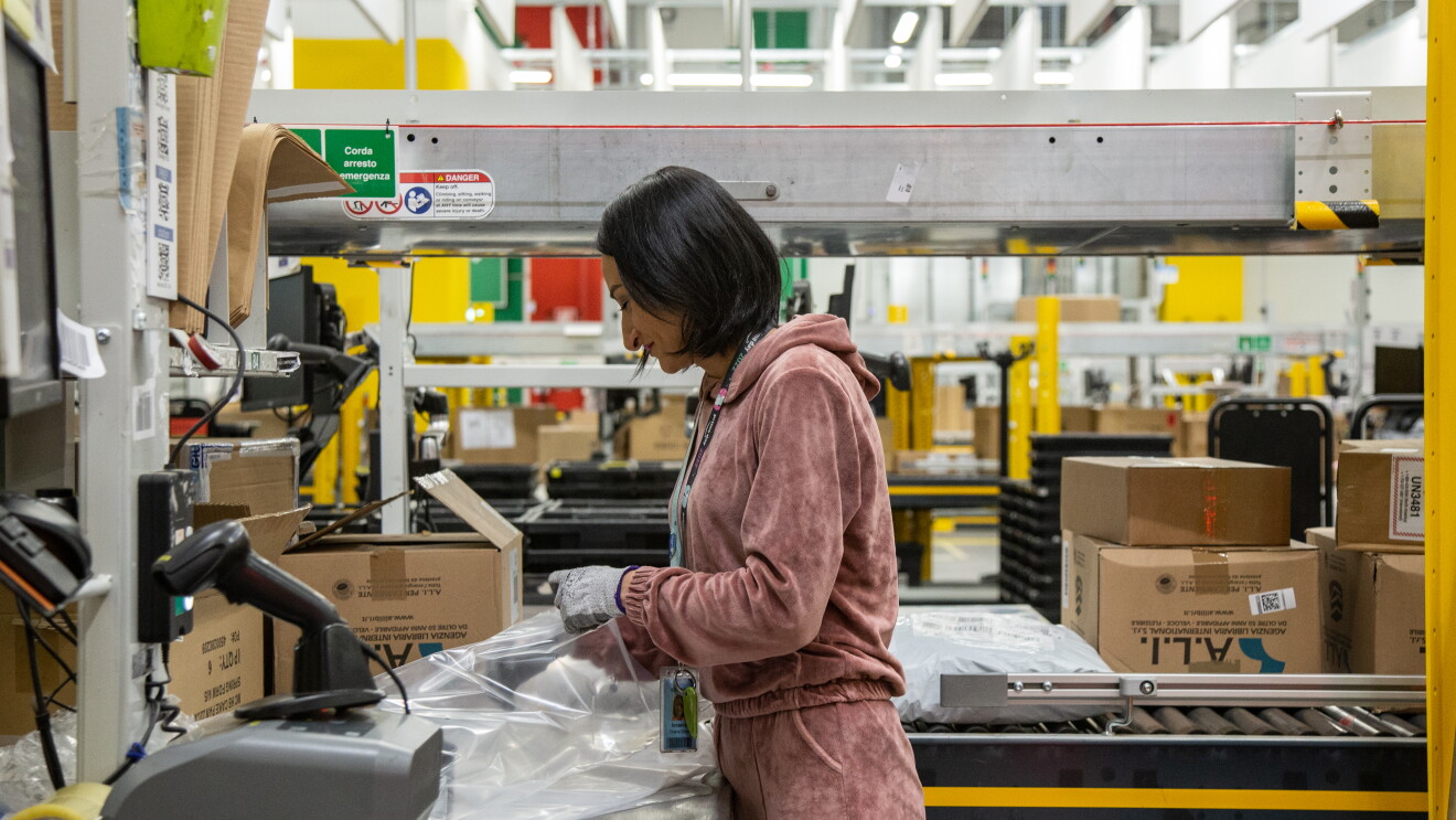a young woman in a pink overall is packing in BGY1