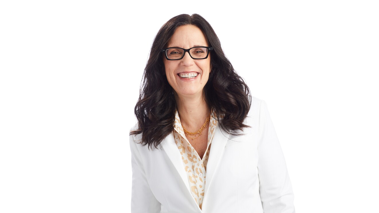 An image of Debra Chrapaty smiling for a professional photo against a white background. 