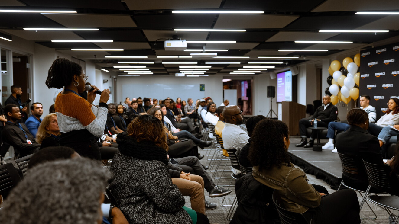 Attendee asking a question to the panelists at the event 