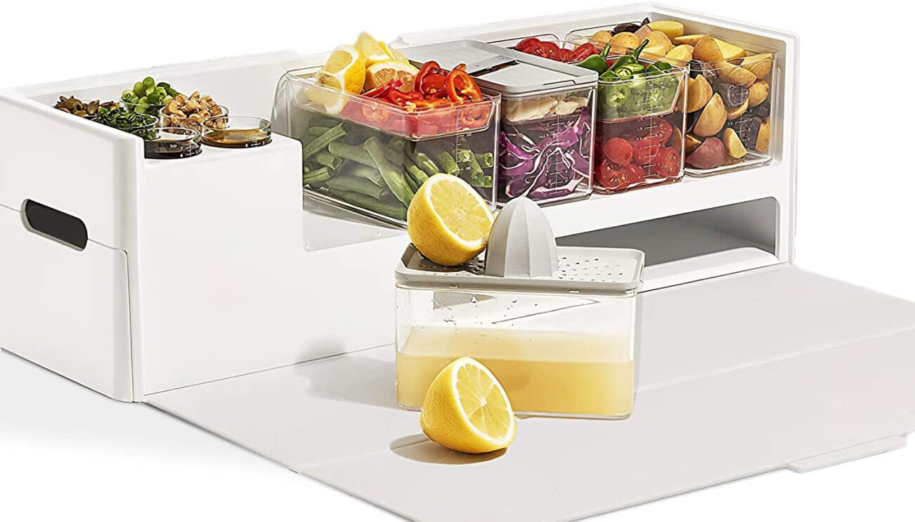 An image of a white container with smaller clear containers stacked on top of it. There is a drawer and a container with a lemon being strained into one of the clear containers.
