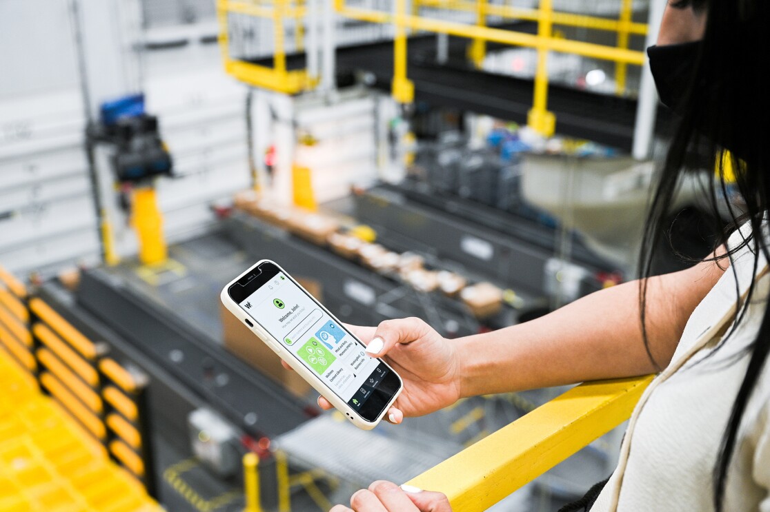 An image of an Amazon employee in a fulfillment center demonstrating how WorkingWell works.