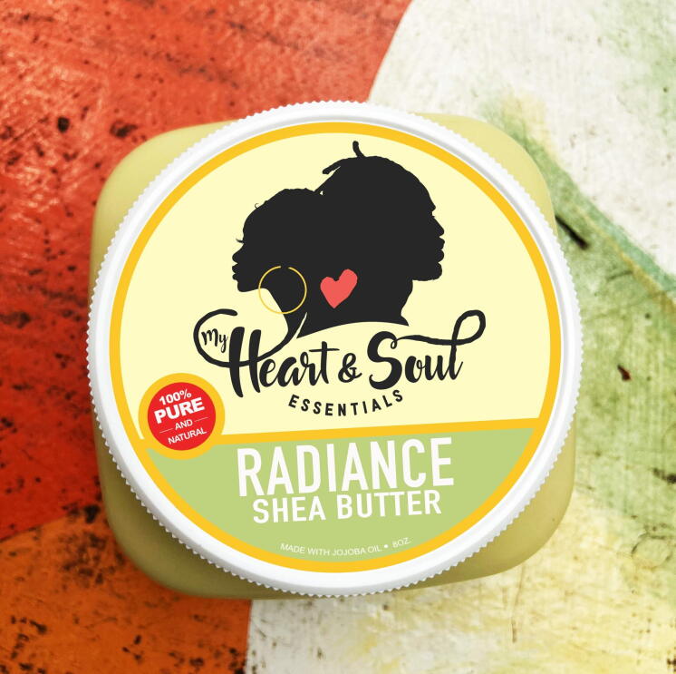A top-down view of a shea butter product from My Heart and Soul Essentials sits on a wooden table.