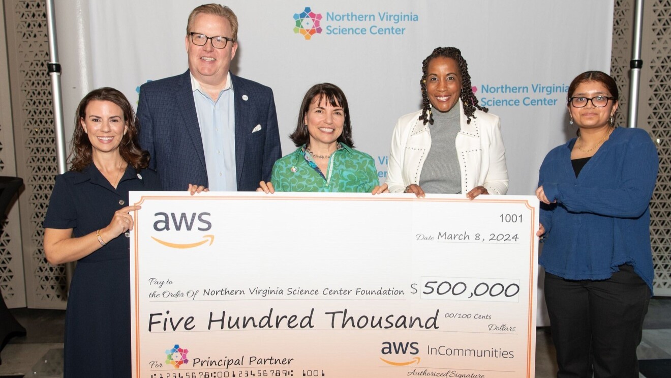 An image of the Northern Virginia Science Center Foundation team accepting a check from Amazon Web Services.