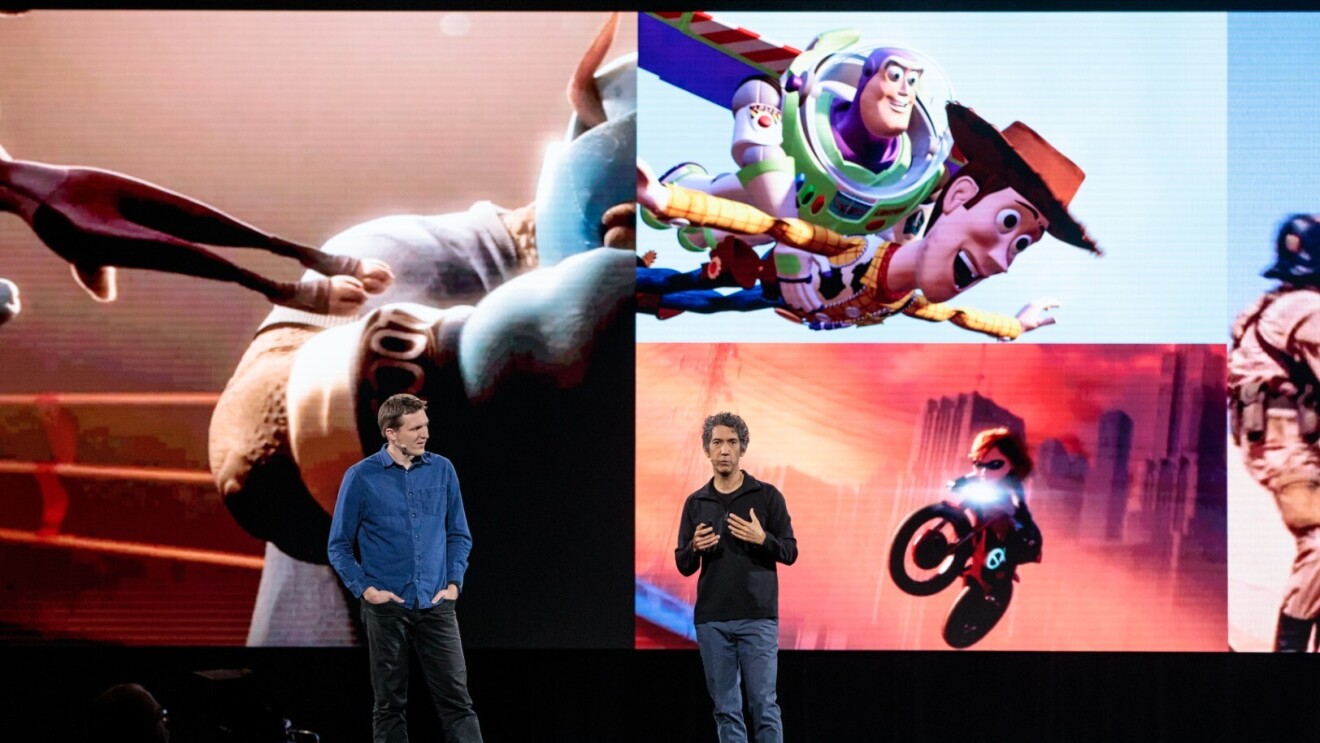 Two men, Morgan Pope and Tony Dohi stand on stage at Amazon re:MARS, in front of a screen showing Disney characters in motion.