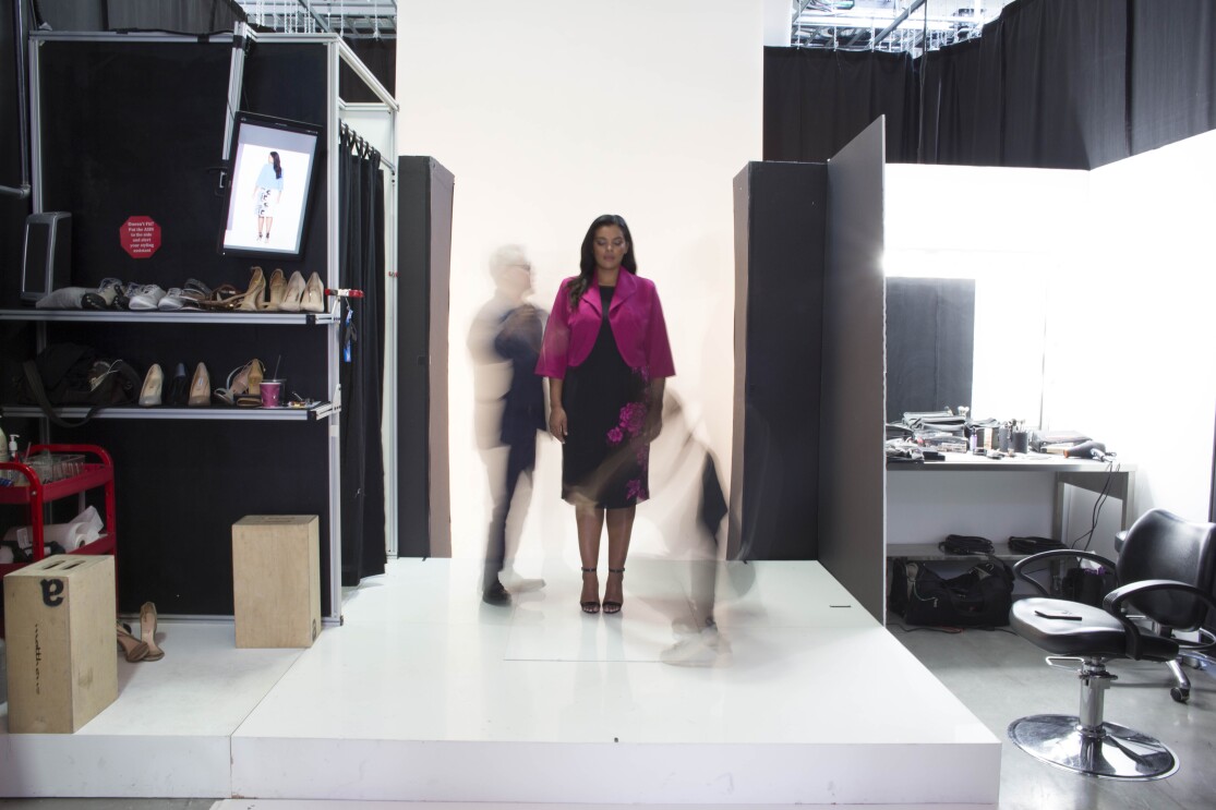 An Amazon Fashion model, wearing a pink and black suit, is photographed at Amazon Fashion's studios.
