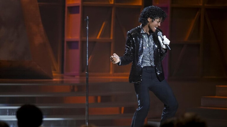 Still from the film. Michael Jackson singing on a stage