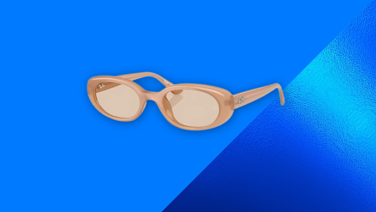 Ray-Ban sunglasses in nude color positioned diagonally on blue surface