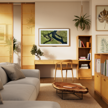An Amazon Ember Artline TV set up on the wall showcasing the Amazon Photos App with Alexa+ integration.
