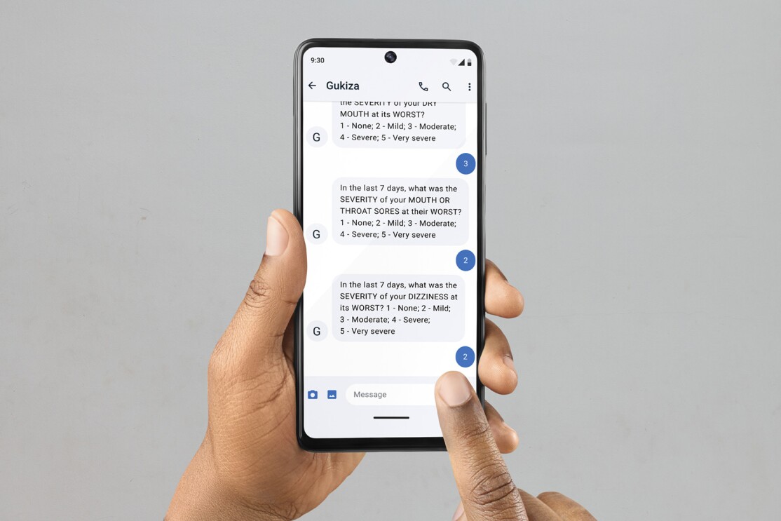 A photo of auto-generated text message prompts about symptoms and side effects through the messaging app “Gukiza,” by HURONE AI on a mobile device.