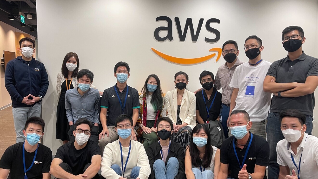 Hackers posing in front of the AWS Sign.