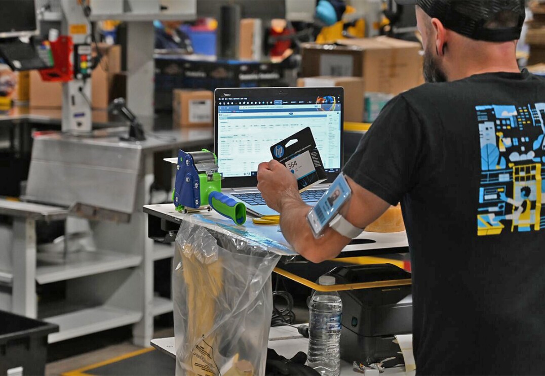 A employee in a fulfilment centre scanning an item