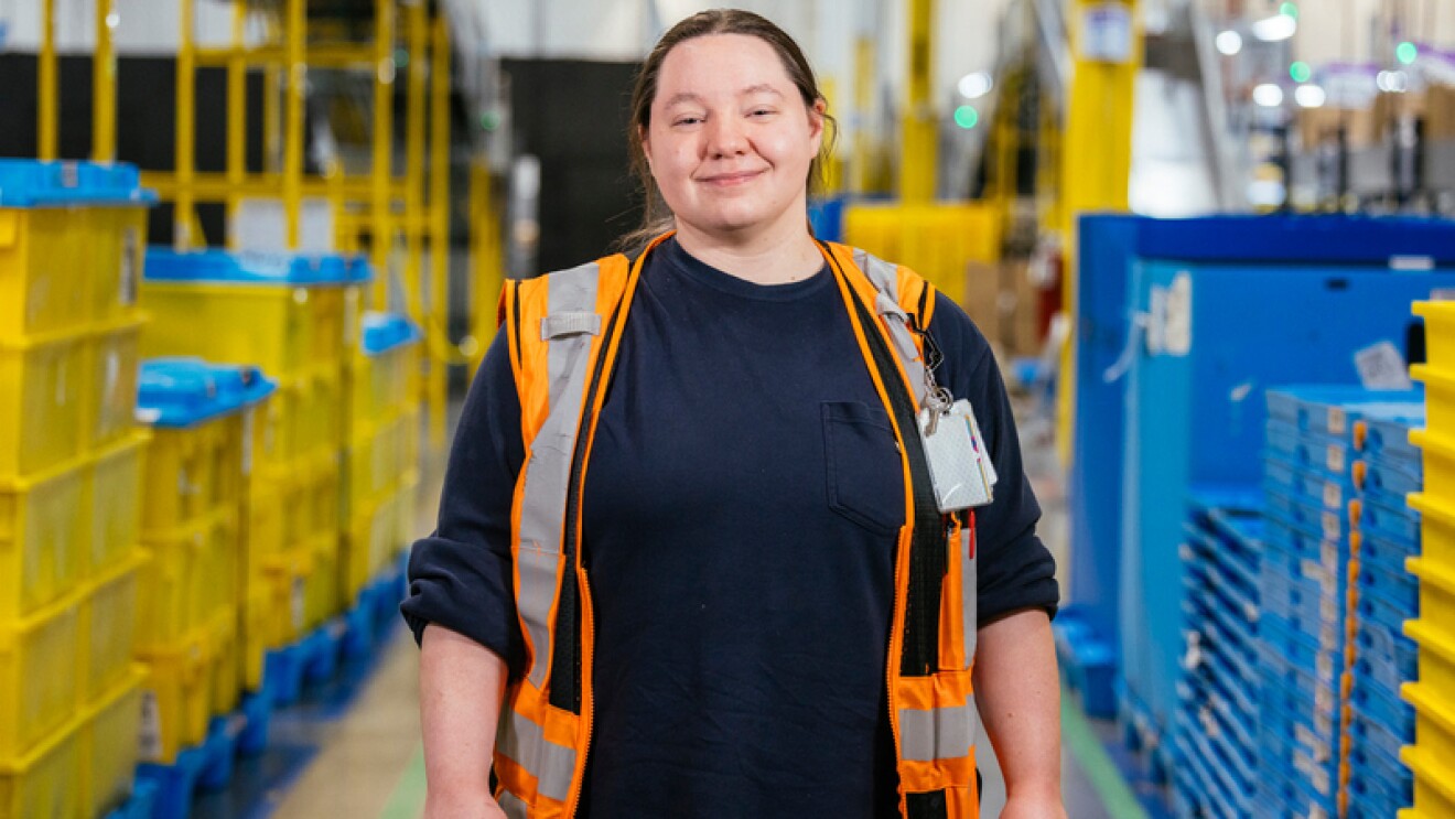 An Amazon employee works in a fulfillment center.