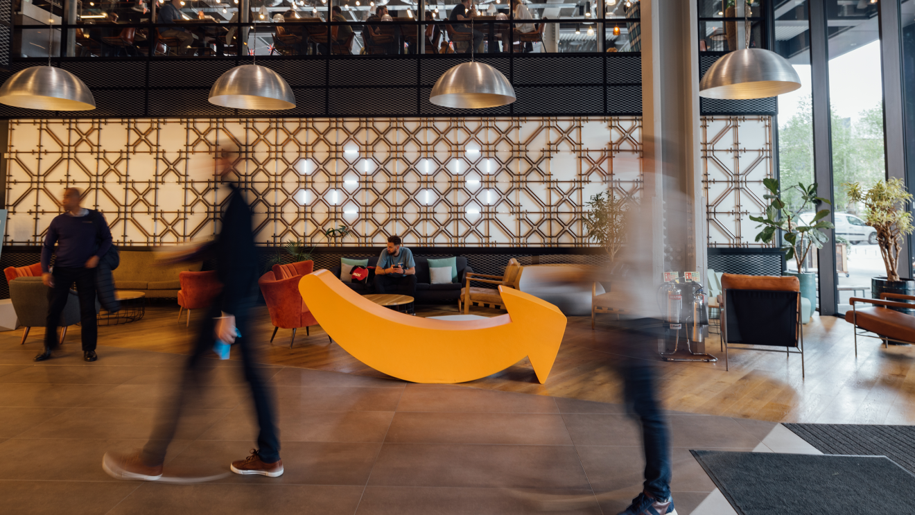 Person walking by the amazon smile in office 