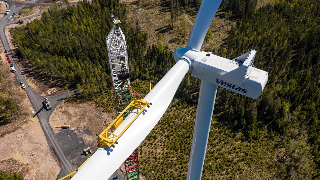 Birds-eye view looking down on a crane assembling a wind turbine.