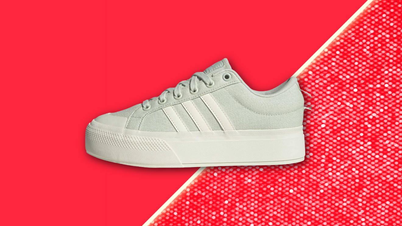 Adidas shoe floating against a vibrant red background.