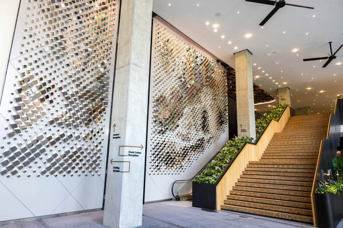 A photo of stairs and an escalator located at the base level atrium of a Amazon HQ2 office at Metropolitan Park in Arlington, Virginia. 