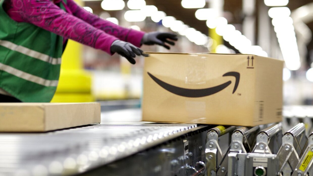 Fulfillment center employee handling a large package