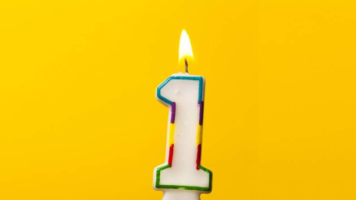 A yellowish-gold background with a lit number 1 candle.