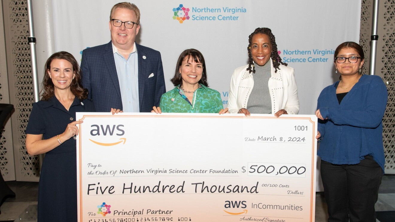 An image of the Northern Virginia Science Center Foundation team accepting a check from Amazon Web Services.
