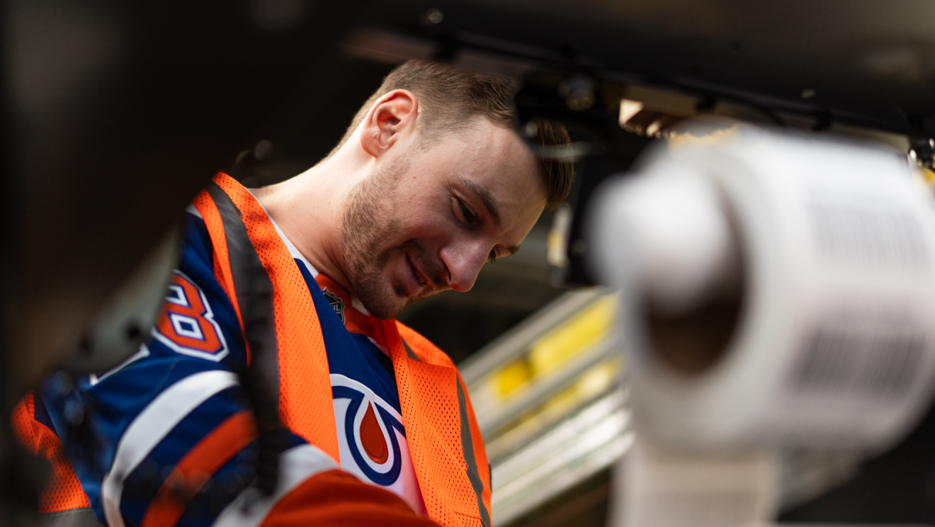 hockey player helping package boxes 