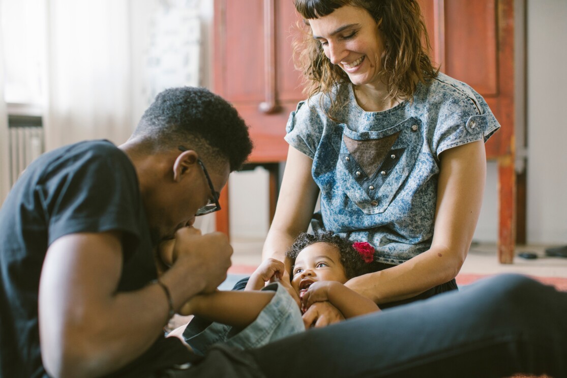 Family enjoying playful moment on floor together