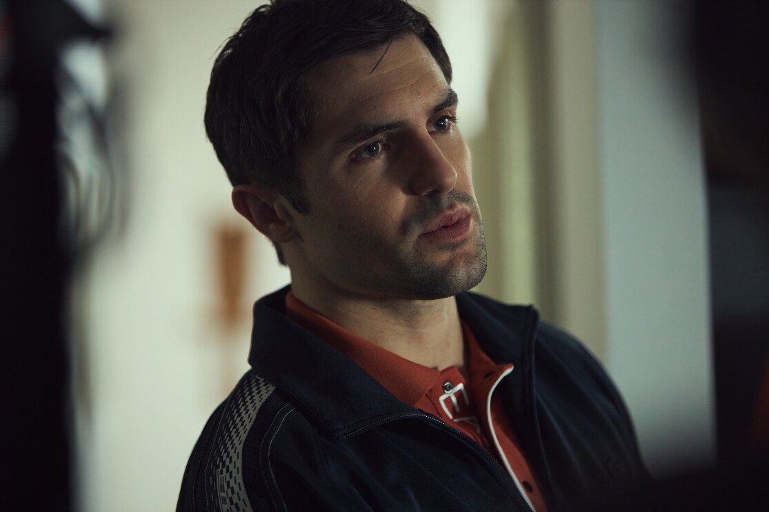 A young man looks ahead pensively