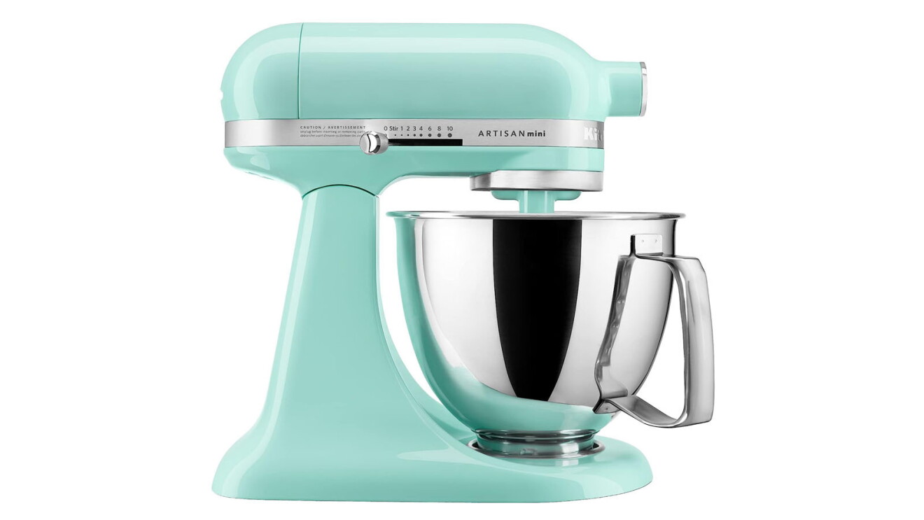 An image of the mini KitchenAid mixer. The base is a bright teal color and the mixer is silver.