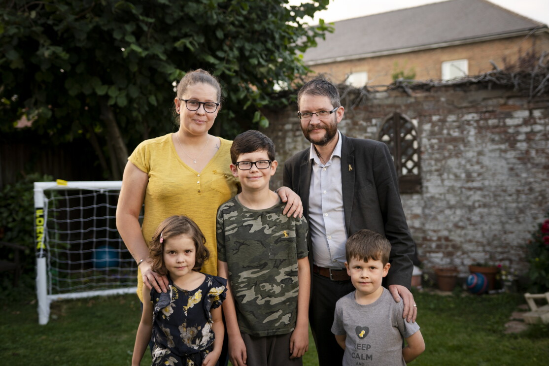 The Hay family, four people, with little Kayla and her brothers, in their garden