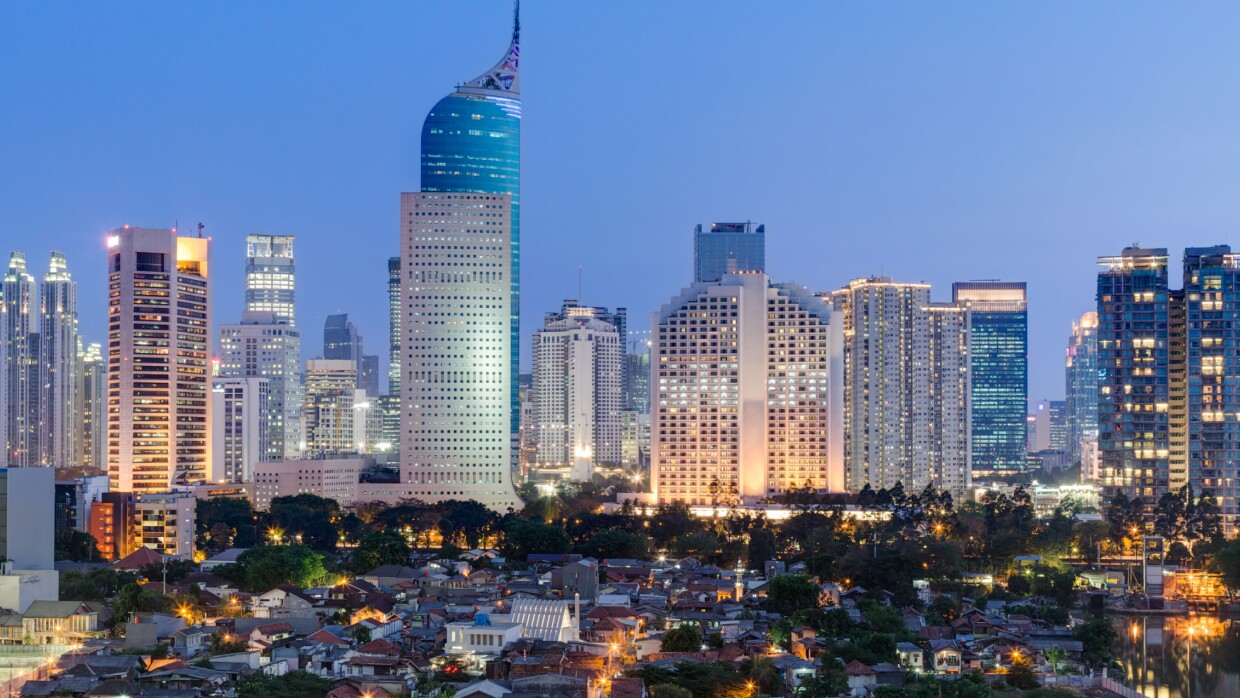 An image of the Jakarta city skyline at dusk.