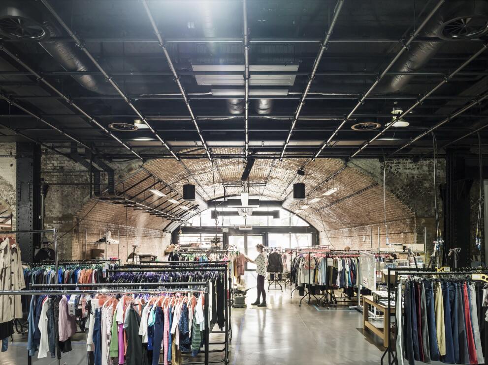 Racks of clothes and architecture inseid Amazon's Fashion Studio in Hoxton