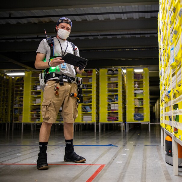 Amazon associate wears a mask while working. Photo taken during COVID-19 pandemic.