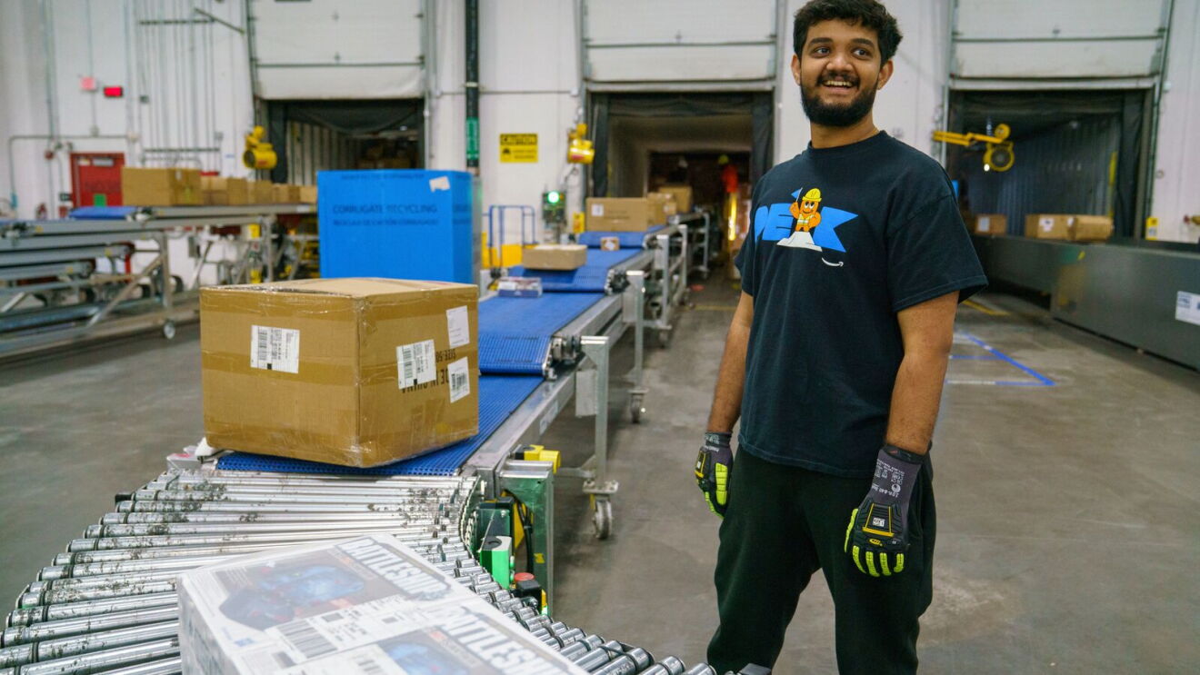 An Amazon associate smiles while checking stock at Amazon BDL4 Windsor, CT, a 3.8-million-square-foot robotics-powered fulfillment center in Windsor, Connecticut.