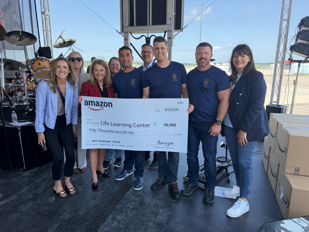 Amazon Air Hub presenting a large check to Life Learning Center employees 