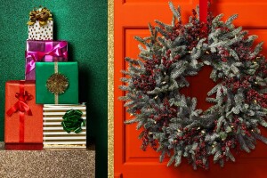 An image of an entryway. There is a large wreath on the red door. Next to the door is a gold, glittery table with wrapped gifts stacked on top of it.