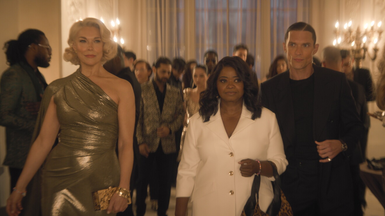 Ride or Die Prime Video: Three elegantly dressed people walking through a crowded formal event with chandeliers