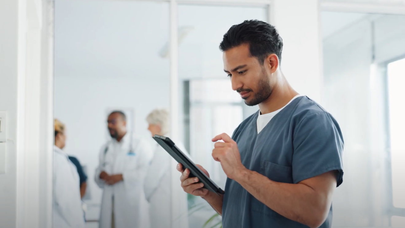 A photo of a healthcare employee working on a laptop. 