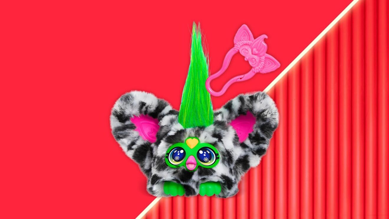 Quirky plush toy with zebra-print fur, green mohawk, and big sparkly eyes