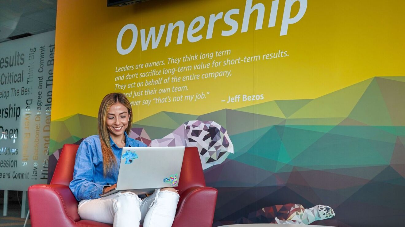 Corporate environment featuring Jeff Bezos quote on ownership.