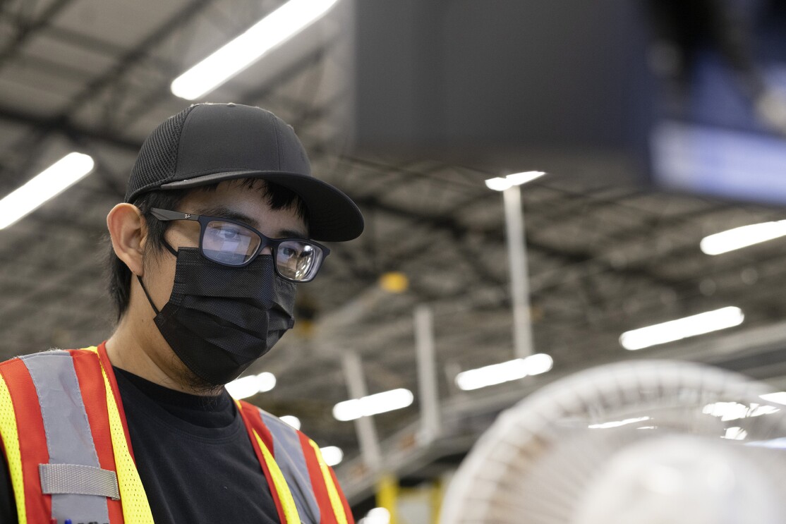 Amazon employee Victor at work. Victor received 6 weeks of paid parental leave support from Amazon when his partner gave birth.
