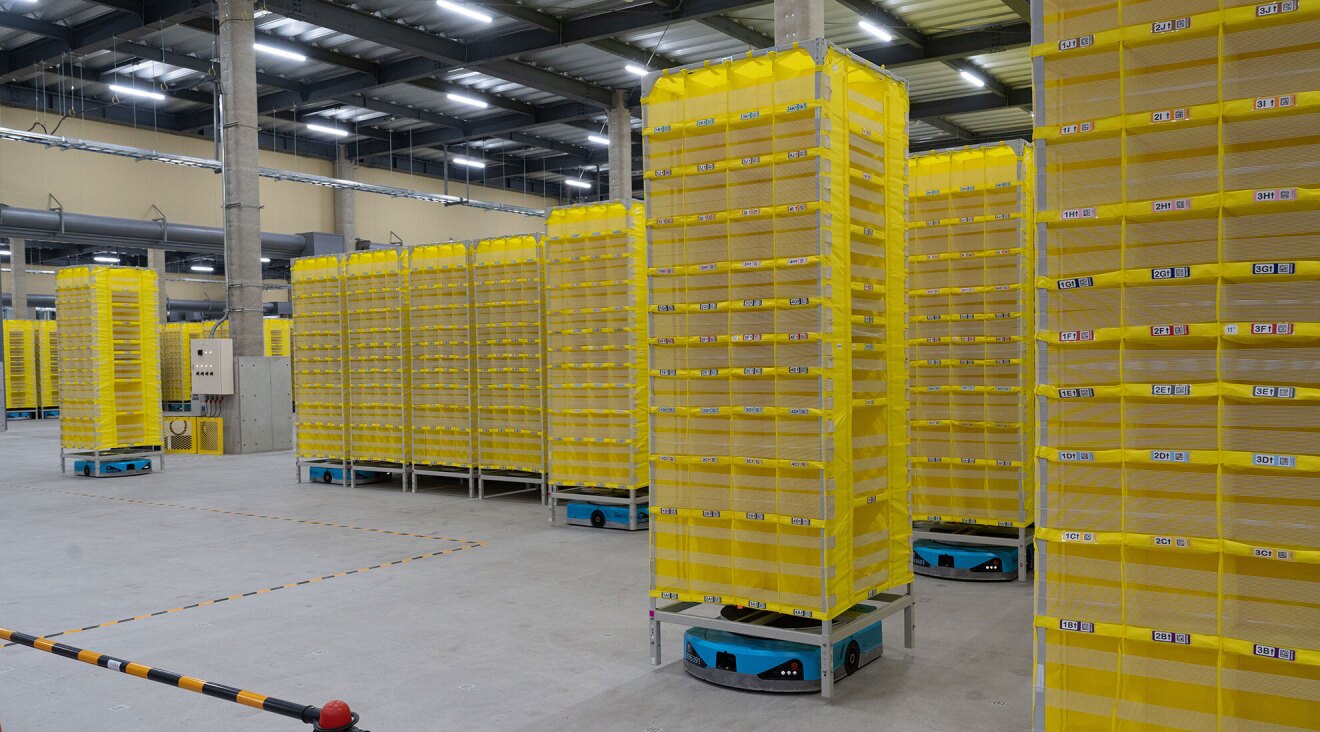 無数の黄色い棚のいくつかに青いロボットが入り、待機している