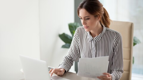 woman with documents and laptop