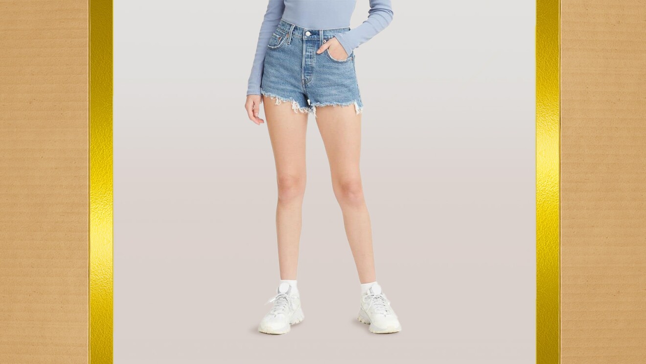 Woman wearing denim shorts and sneakers